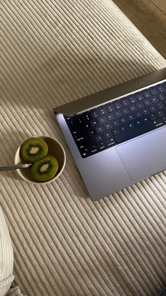 Wellness founder envisioning marketing strategies without Instagram on laptop in bed